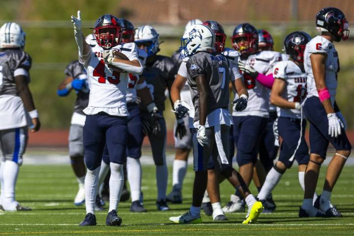 Coronado linebacker William Bittman (43) signals his fumble recovery and the new direction of p ...