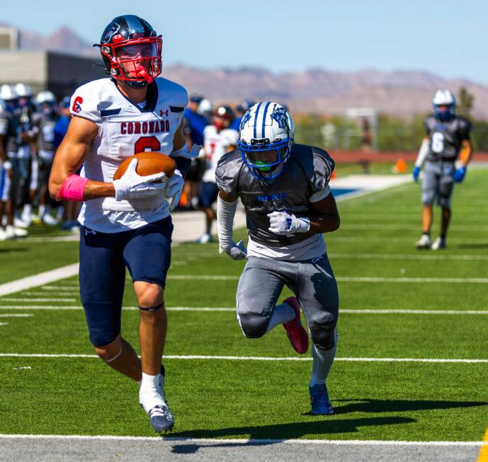 Coronado wide receiver JJ Buchanan (6) runs into the end zone after a catch as Basic defensive ...