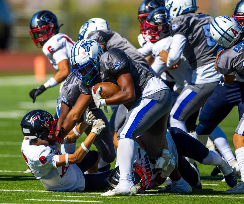 Basic running back Lynn Saltmarch (23) is stopped by Coronado safety Caden Erickson (11) teamma ...