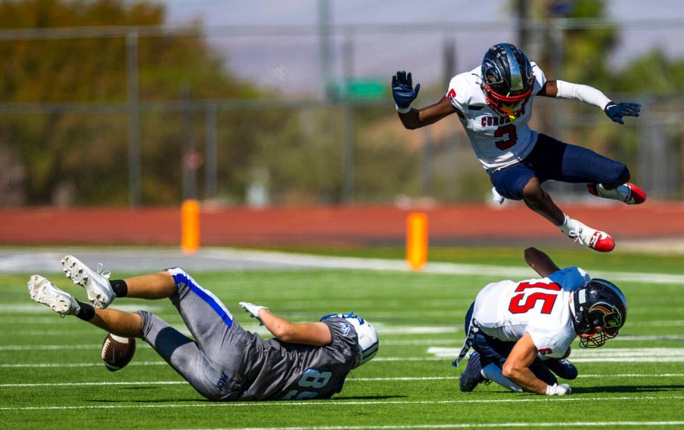 Basic wide receiver Hunter McGory (89) loses a reception attempt as Coronado linebacker Kael Fr ...