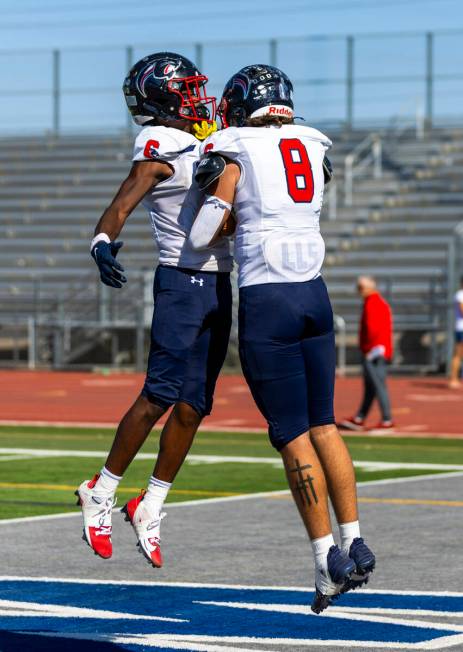 Coronado tight end Neville Roberts (8) celebrates a touchdown with running back Ty Tinner (3) a ...