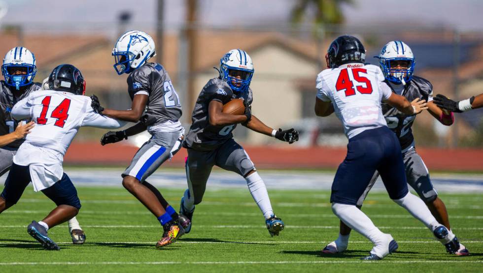 Basic fullback Elijah Jones (8) looks to blast through a gap as Coronado defensive end Aiden Gd ...