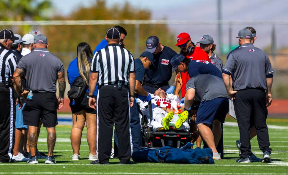 Coronado defensive back Scott "Bubba" Holper (13) is taken off the field by medical p ...