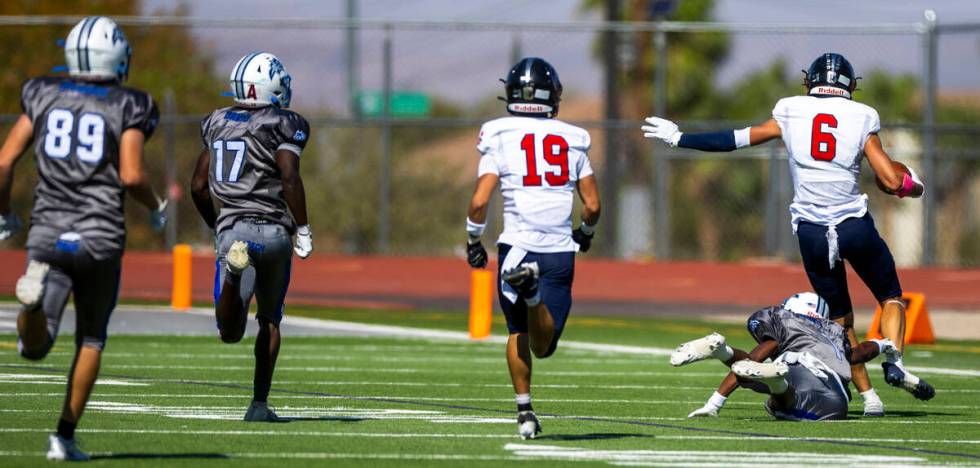 Coronado wide receiver JJ Buchanan (6) escapes a diving tackle attempt by Basic defensive back ...