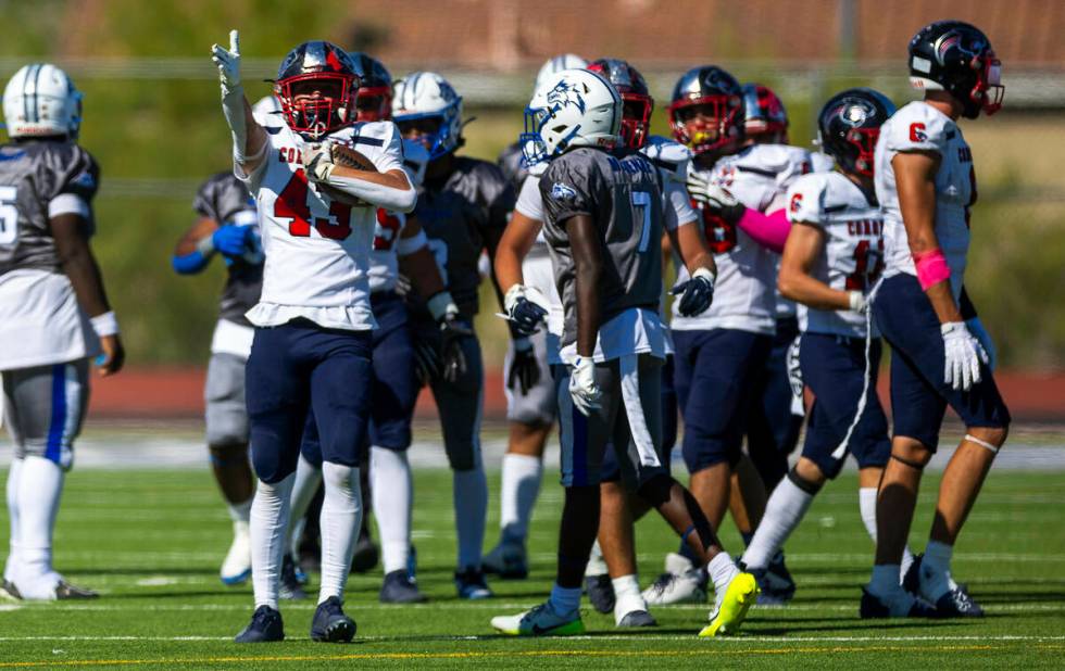 Coronado linebacker William Bittman (43) signals his fumble recovery and the new direction of p ...