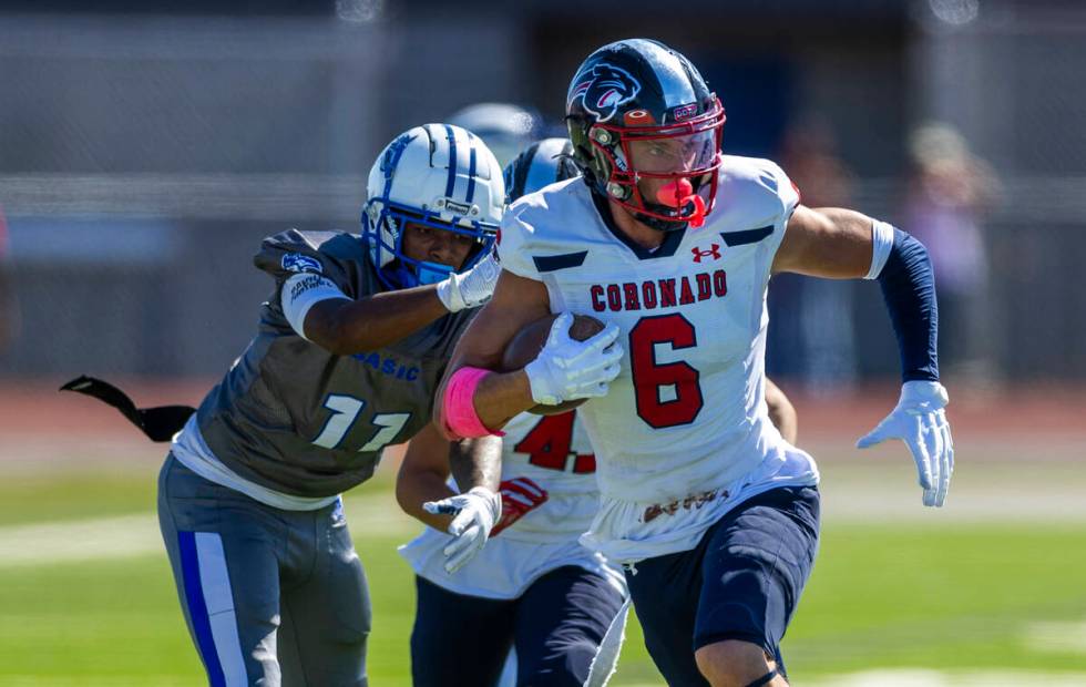 Coronado defensive back JJ Buchanan (6) brushes off a tackle attempt after an interception by B ...