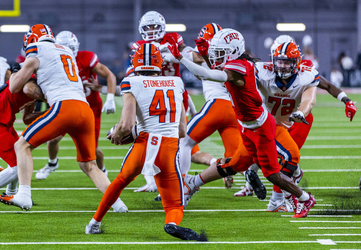 Syracuse Orange punter Jack Stonehouse (41) is unable to punt as UNLV wide receiver Ricky White ...