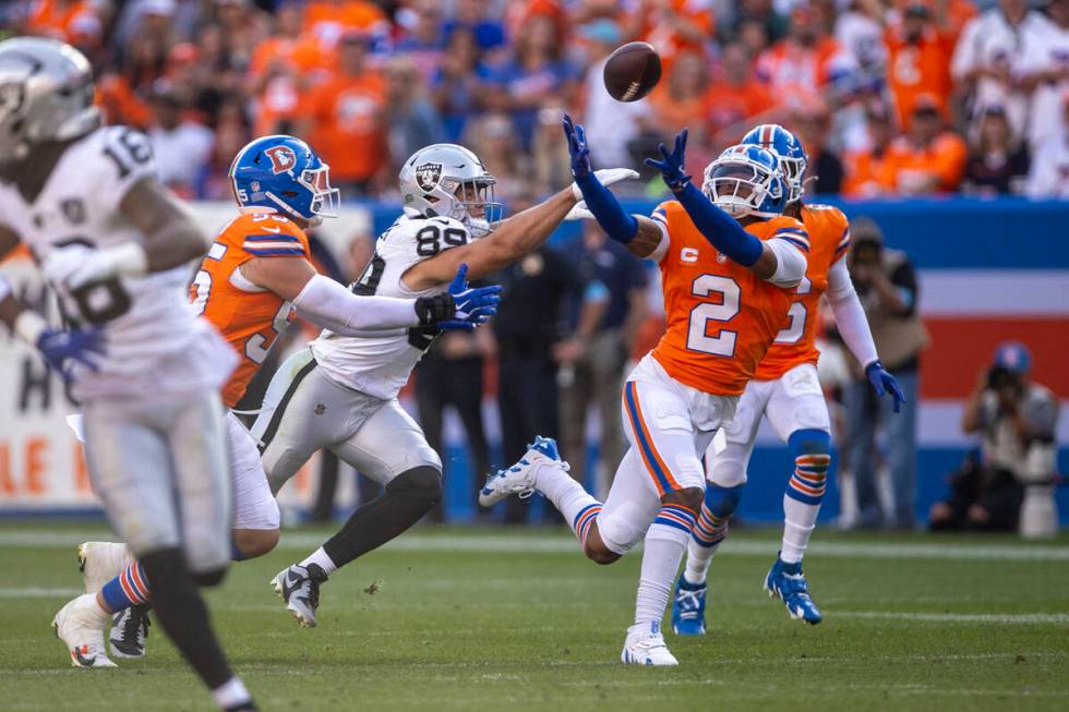 Denver Broncos cornerback Pat Surtain II (2) reaches to intercept a pass intended for Raiders t ...