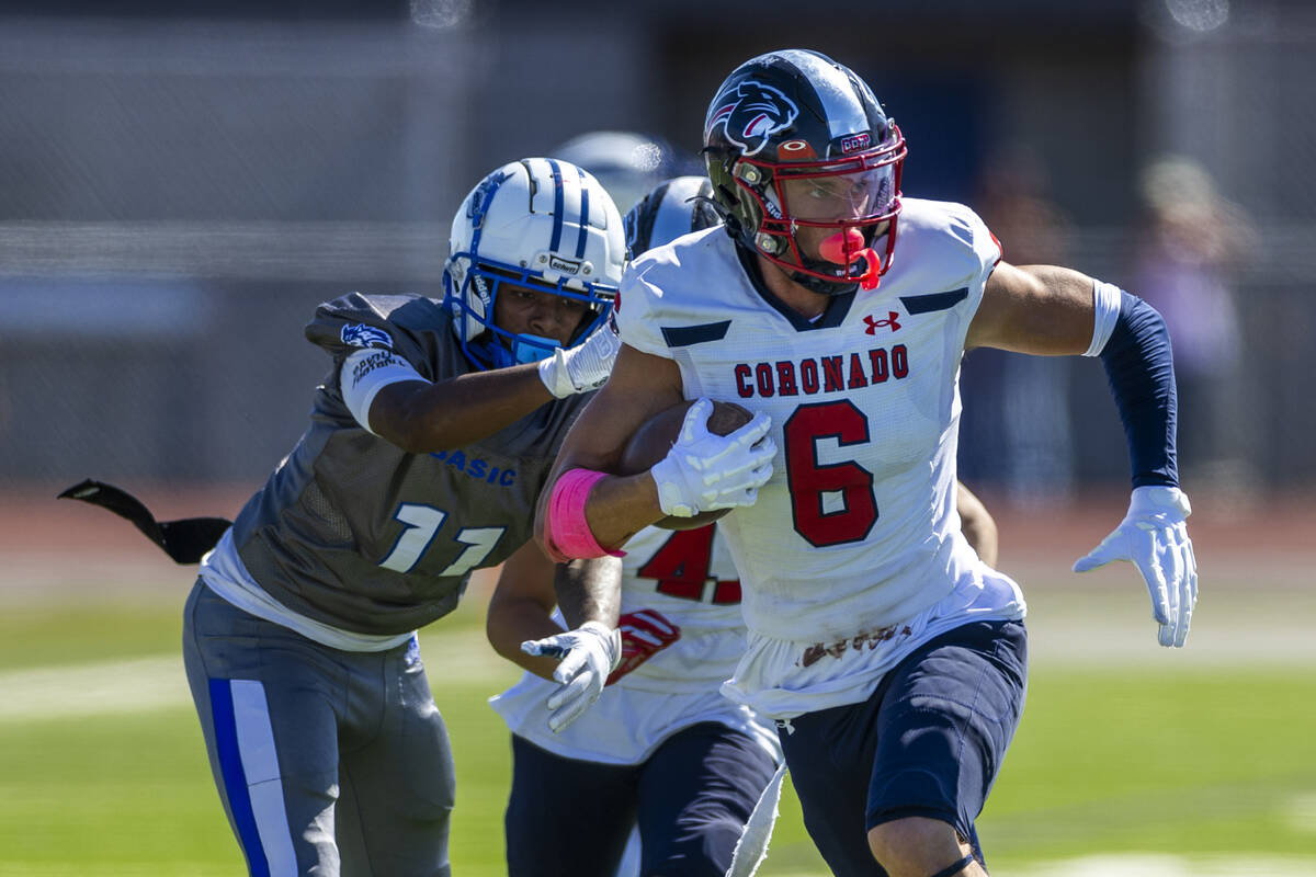 Coronado defensive back JJ Buchanan (6) brushes off a tackle attempt after an interception by B ...