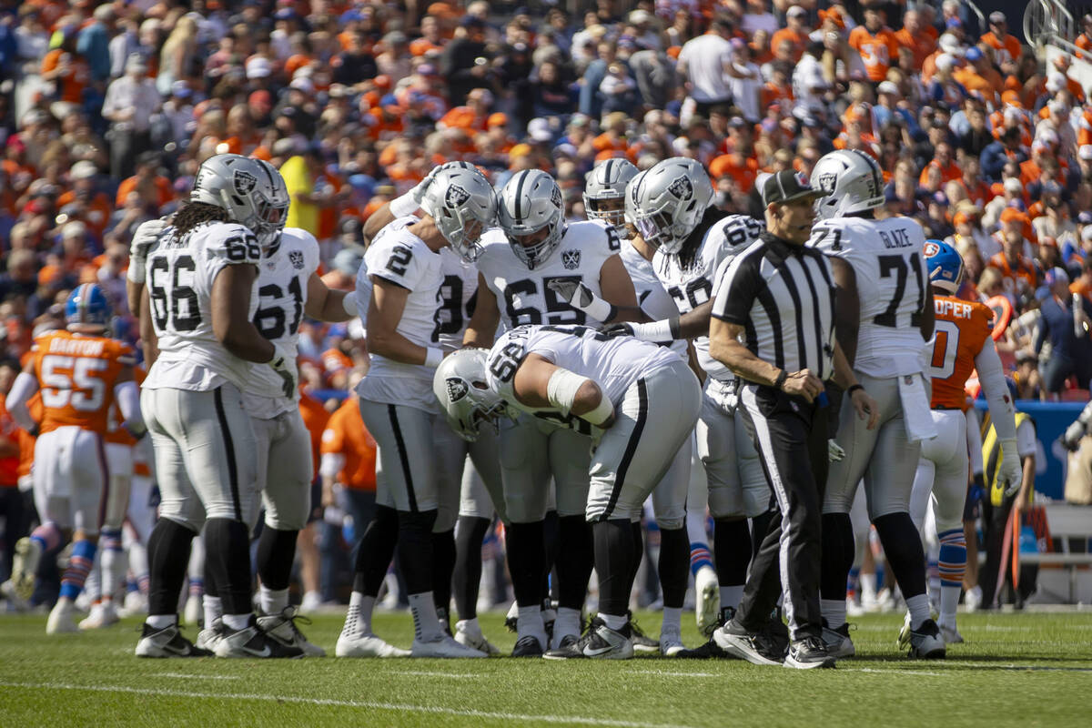 Raiders guard Jackson Powers-Johnson (58) takes a moment to recover from a hit on the field dur ...