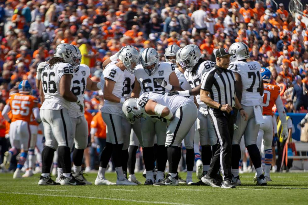 Raiders guard Jackson Powers-Johnson (58) takes a moment to recover from a hit on the field dur ...