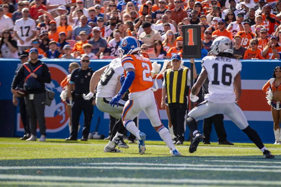 Denver Broncos cornerback Pat Surtain II (2) intercepts a pass intended for Raiders tight end B ...