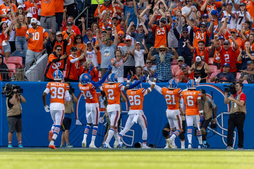 Denver Broncos cornerback Pat Surtain II (2) and other defenders celebrate his second intercept ...