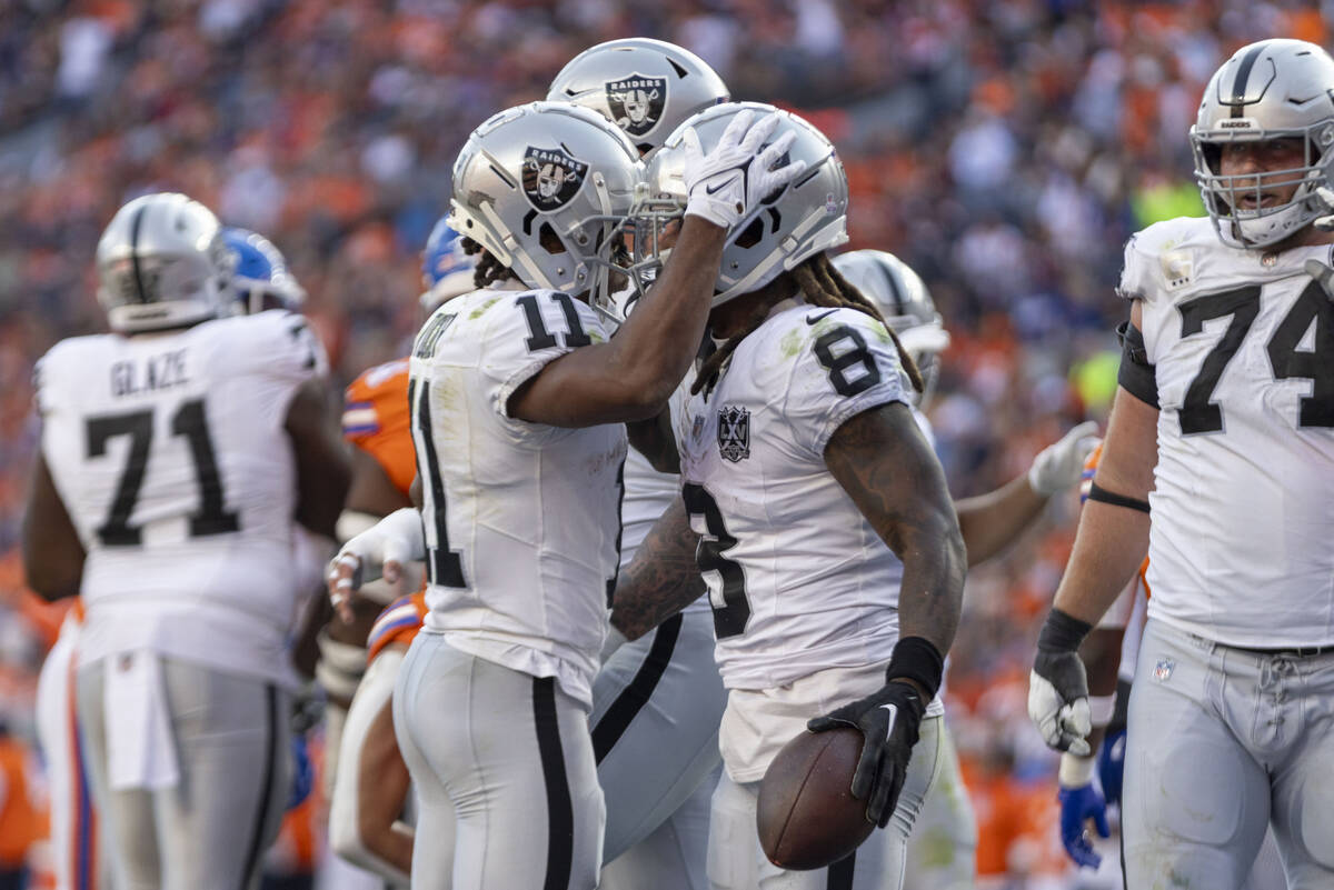 Raiders running back Ameer Abdullah (8) celebrates his touchdown with wide receiver Tre Tucker ...