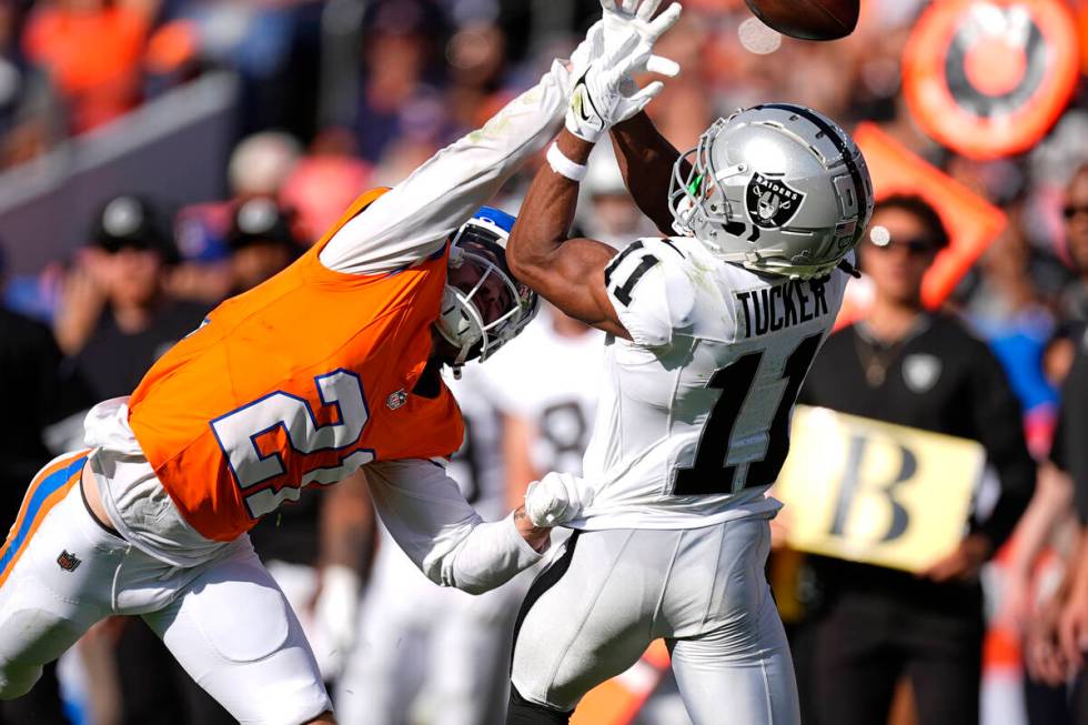 Denver Broncos cornerback Riley Moss (21) deflects a pass intended for Las Vegas Raiders wide r ...