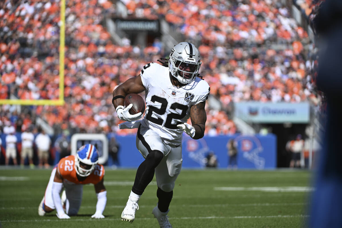 Las Vegas Raiders running back Alexander Mattison (22) rushes during the first half of an NFL f ...