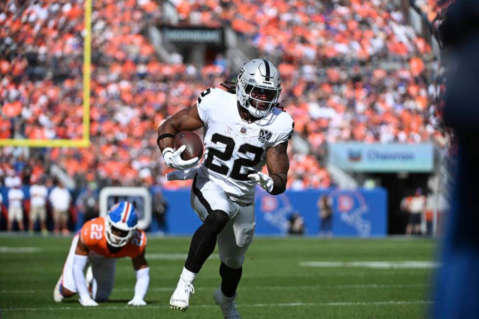 Las Vegas Raiders running back Alexander Mattison (22) rushes during the first half of an NFL f ...