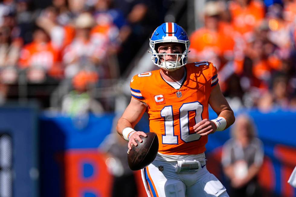 Denver Broncos quarterback Bo Nix looks downfield during the first half of an NFL football game ...