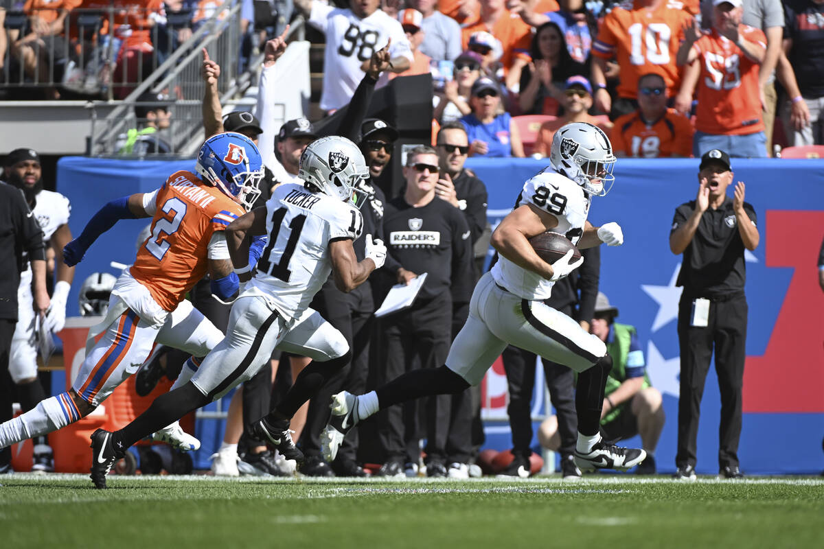 Las Vegas Raiders tight end Brock Bowers outruns Denver Broncos cornerback Pat Surtain II (2) f ...