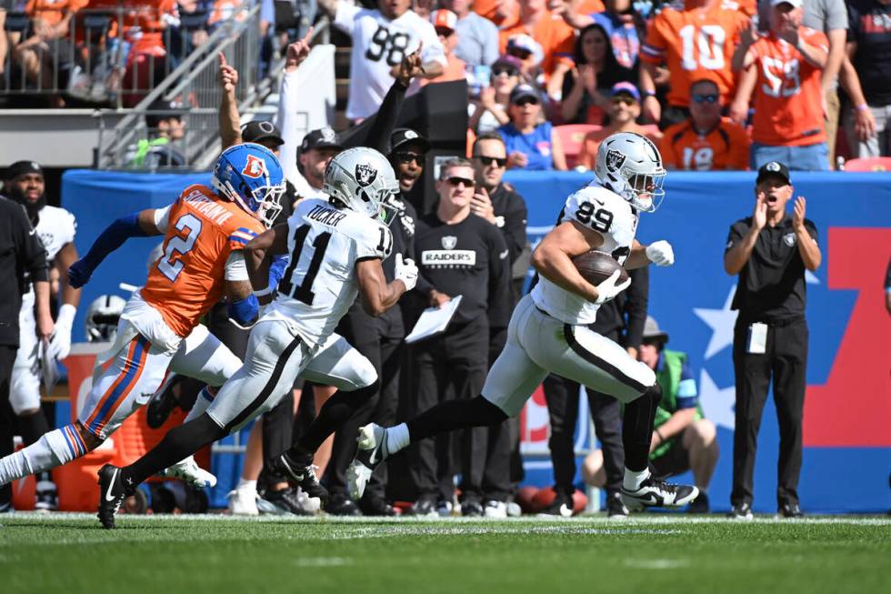 Las Vegas Raiders tight end Brock Bowers outruns Denver Broncos cornerback Pat Surtain II (2) f ...