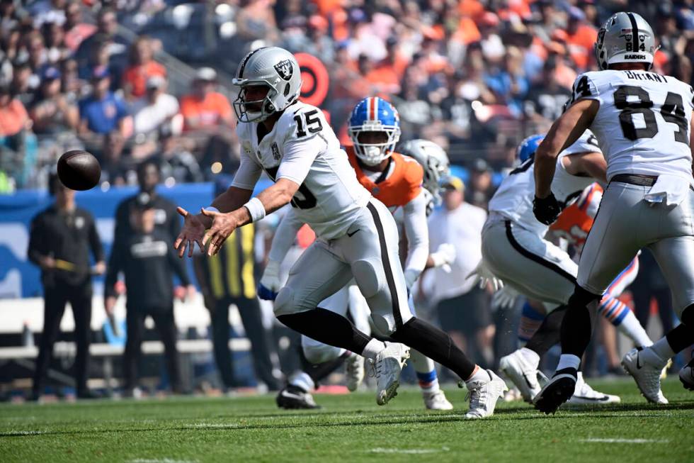 Las Vegas Raiders quarterback Gardner Minshew laterals during the first half of an NFL football ...