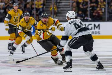 Golden Knights right wing Alexander Holtz (26) eyes the puck against Los Angeles Kings defensem ...