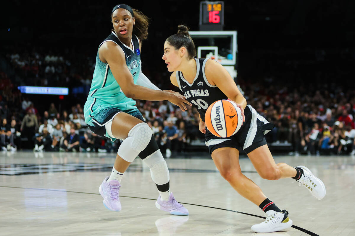 Aces guard Kelsey Plum (10) dribbles the ball while New York Liberty forward Kennedy Burke (2) ...