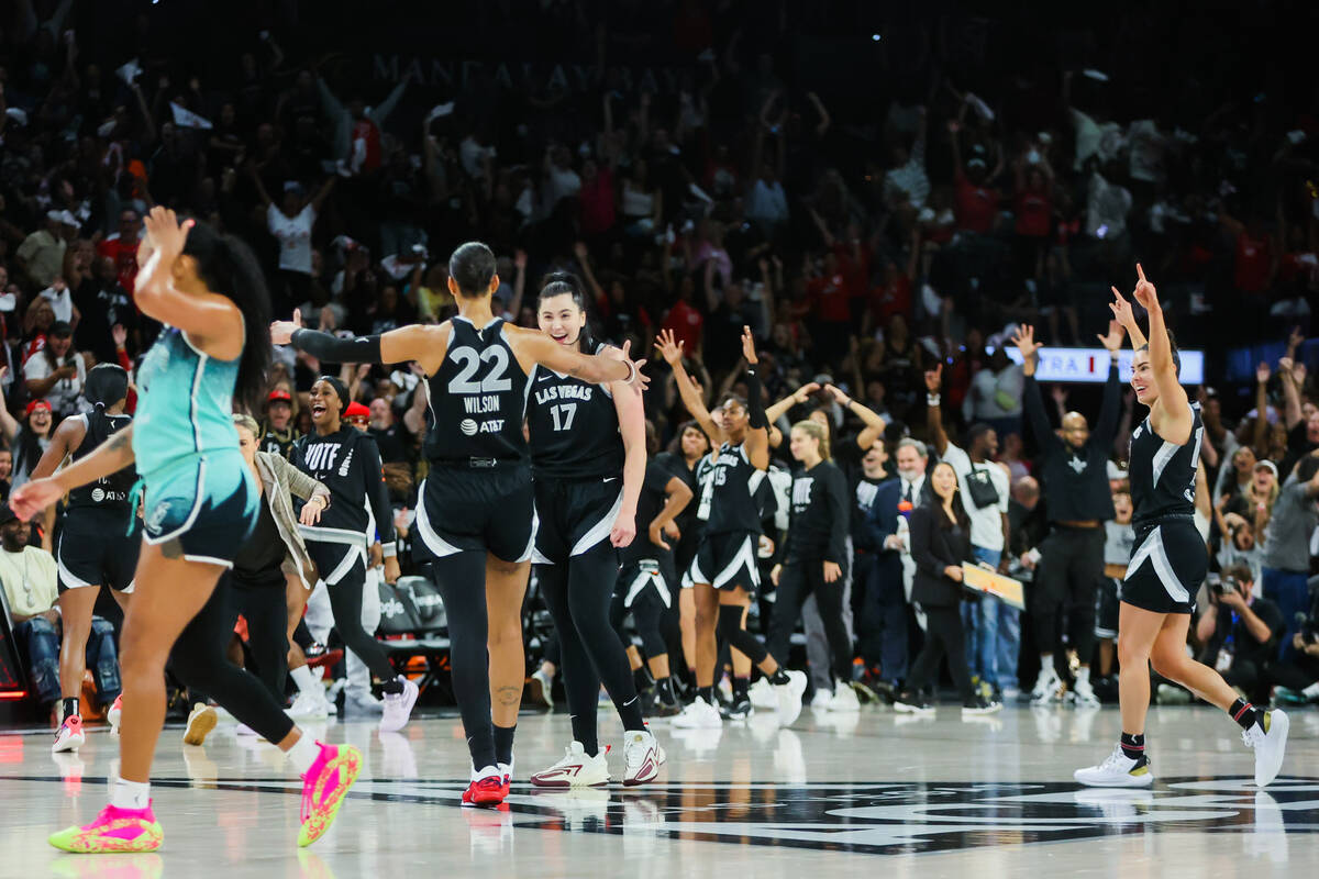 Aces center A'ja Wilson (22) and center Megan Gustafson (17) celebrate a shot by Jackie Young, ...