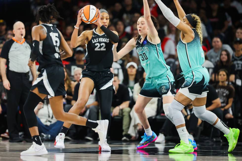 Aces center A'ja Wilson (22) looks to pass the ball to Aces guard Tiffany Hayes (15) during gam ...