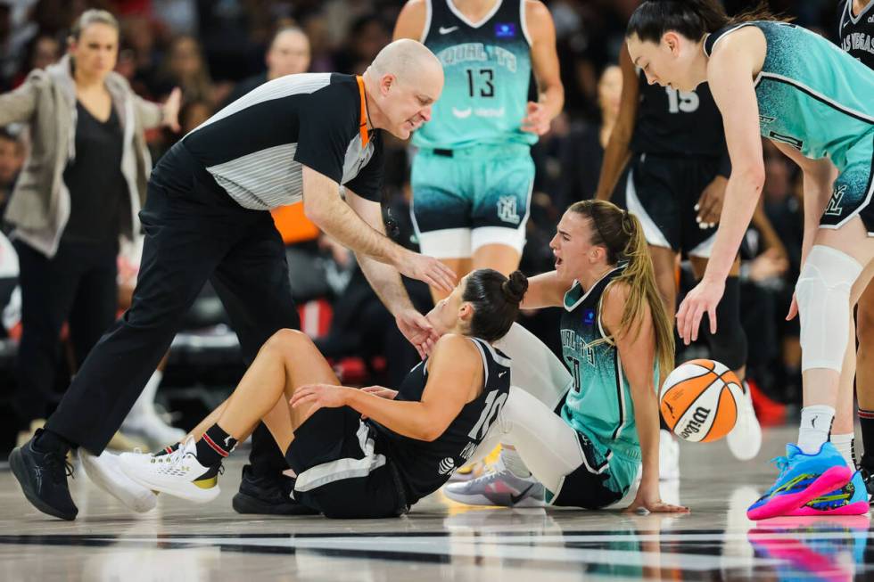 Aces guard Kelsey Plum (10) and New York Liberty guard Sabrina Ionescu (20) react to a referee ...