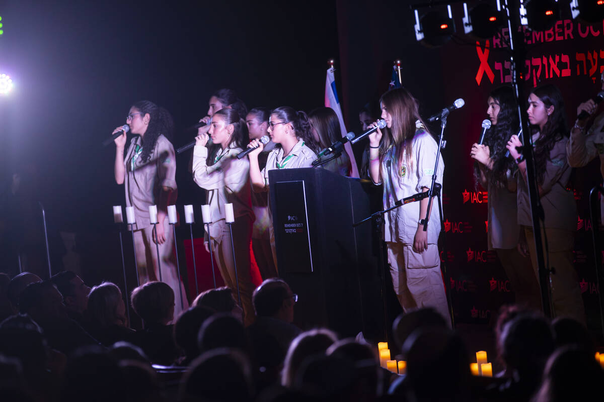 People sing during an event marking one year since the Oct. 7 terrorist attacks on Israel at La ...