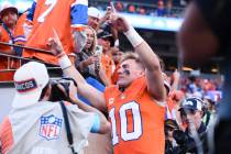 Denver Broncos quarterback Bo Nix gestures to fans as he heads off the field after an NFL footb ...