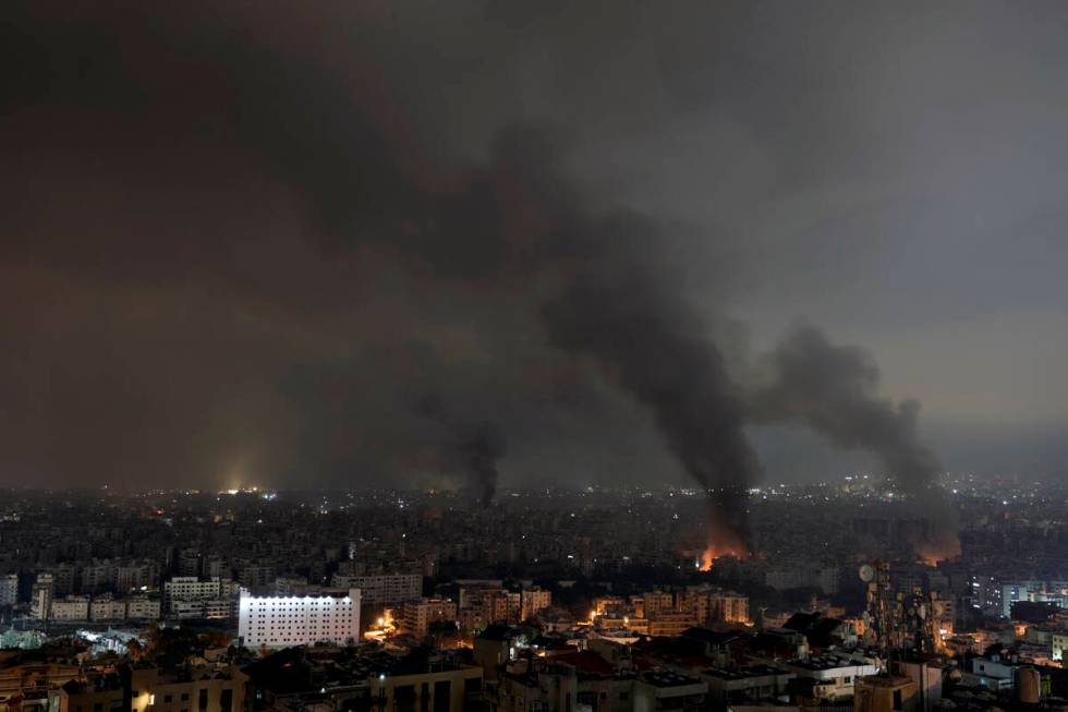 Flames and smoke rise from an Israeli airstrike in Dahiyeh, Beirut, Lebanon, early Monday, Oct. ...