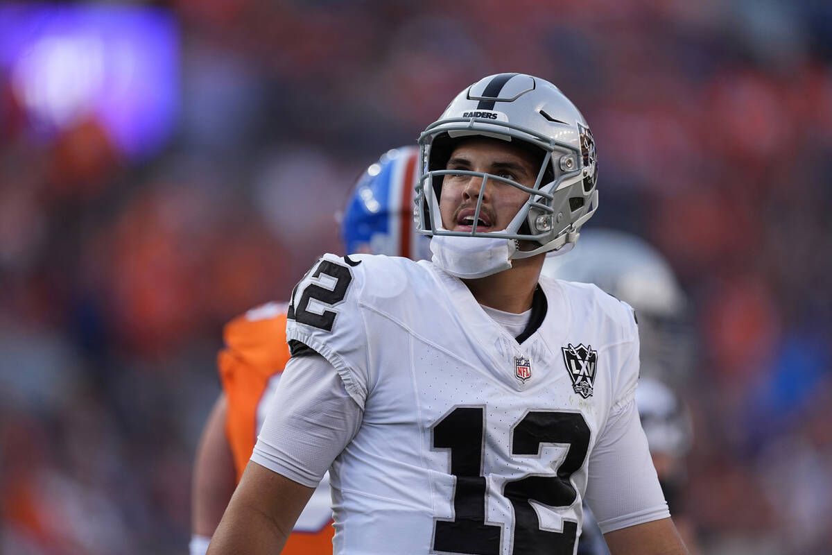 Las Vegas Raiders quarterback Aidan O'Connell looks at the scoreboard after throwing an incompl ...