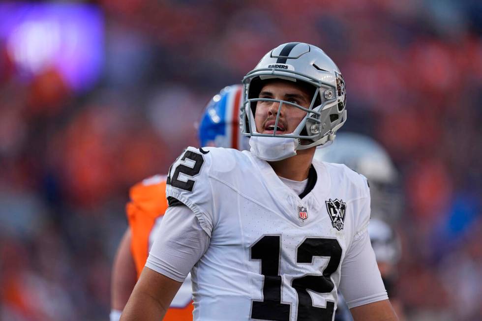 Las Vegas Raiders quarterback Aidan O'Connell looks at the scoreboard after throwing an incompl ...