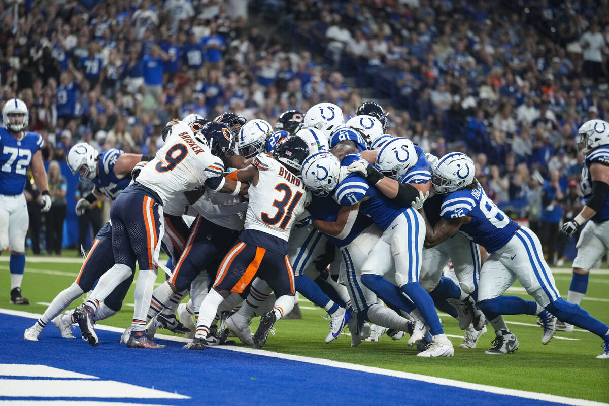 Indianapolis Colts running back Trey Sermon (27) is pushed across the goal line for a touchdown ...