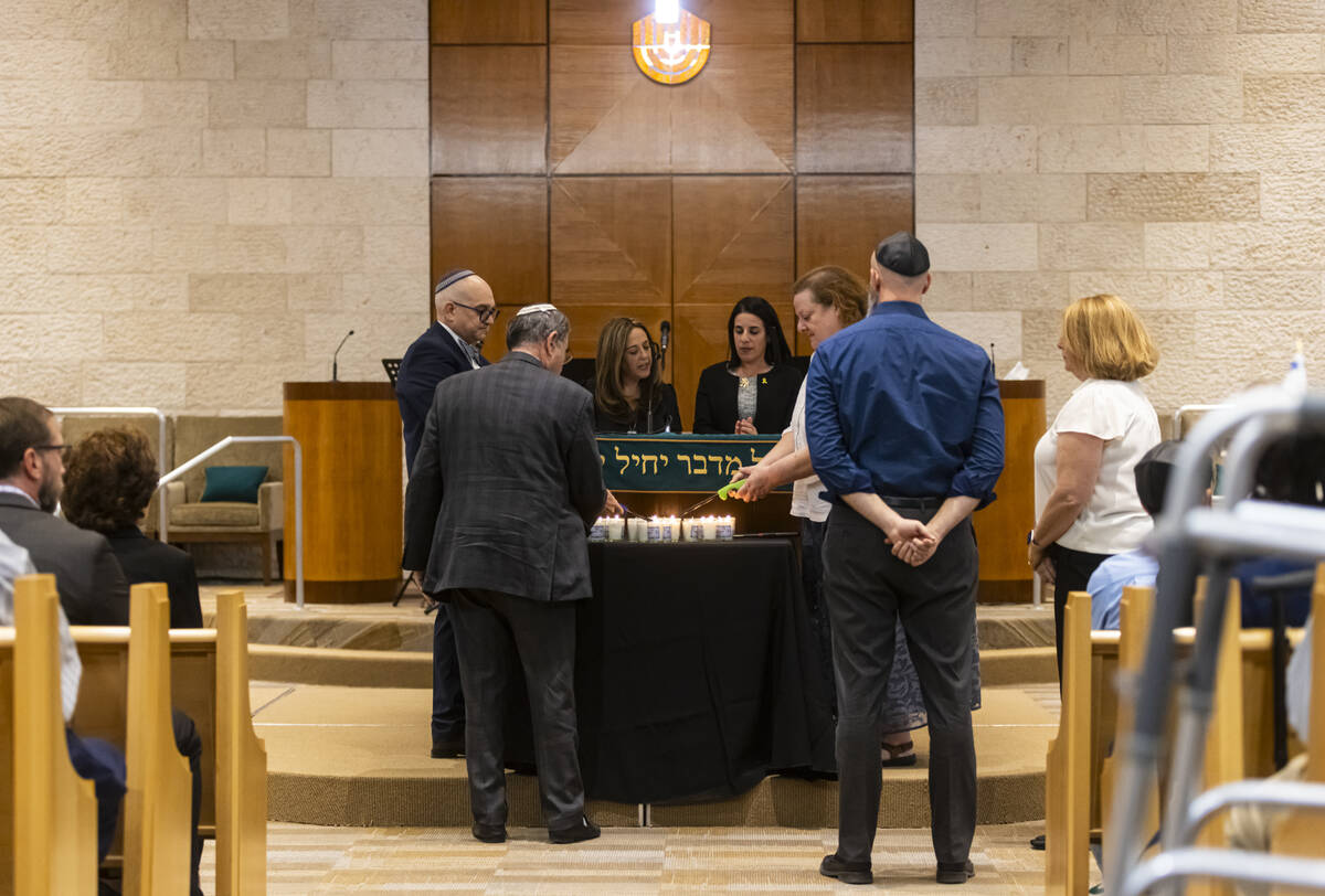 Candles are lit during a ceremony at Midbar Kodesh Temple marking one year since the Oct. 7 ter ...