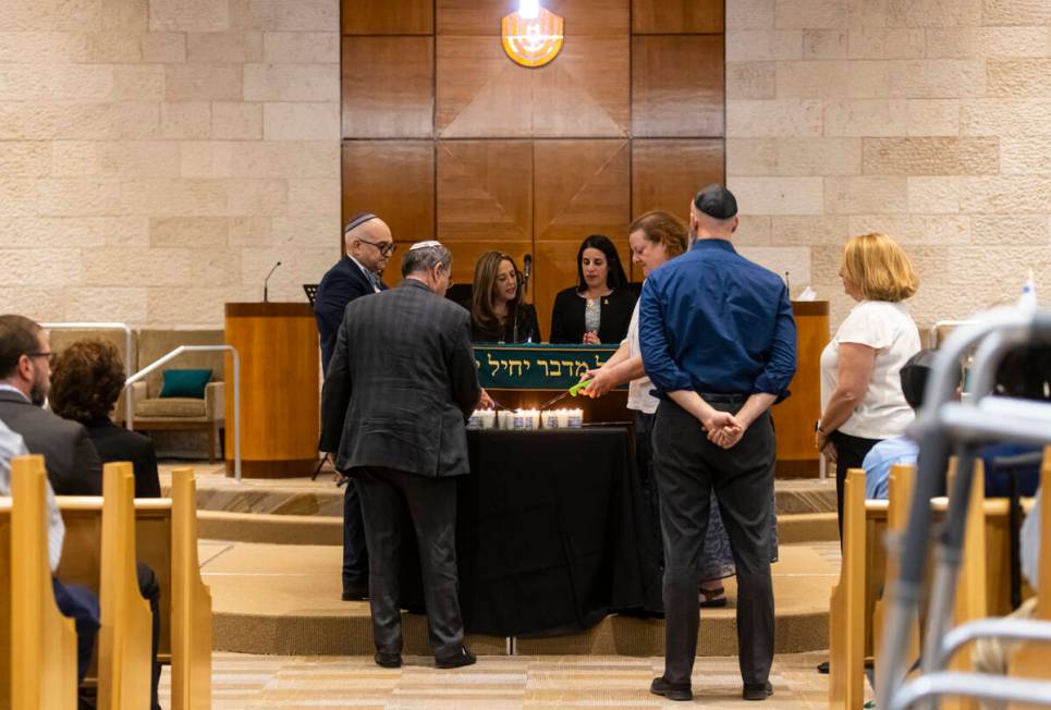 Candles are lit during a ceremony at Midbar Kodesh Temple marking one year since the Oct. 7 ter ...