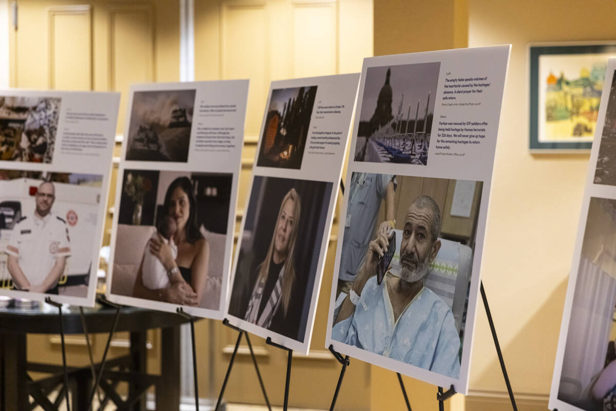 Images of hostages captured by Hamas are seen on display during a ceremony at Midbar Kodesh Tem ...