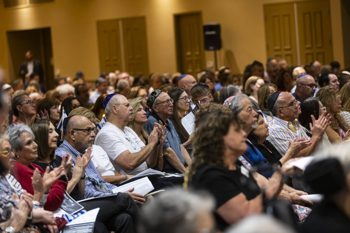 People clap during a ceremony at Midbar Kodesh Temple marking one year since the Oct. 7 terrori ...