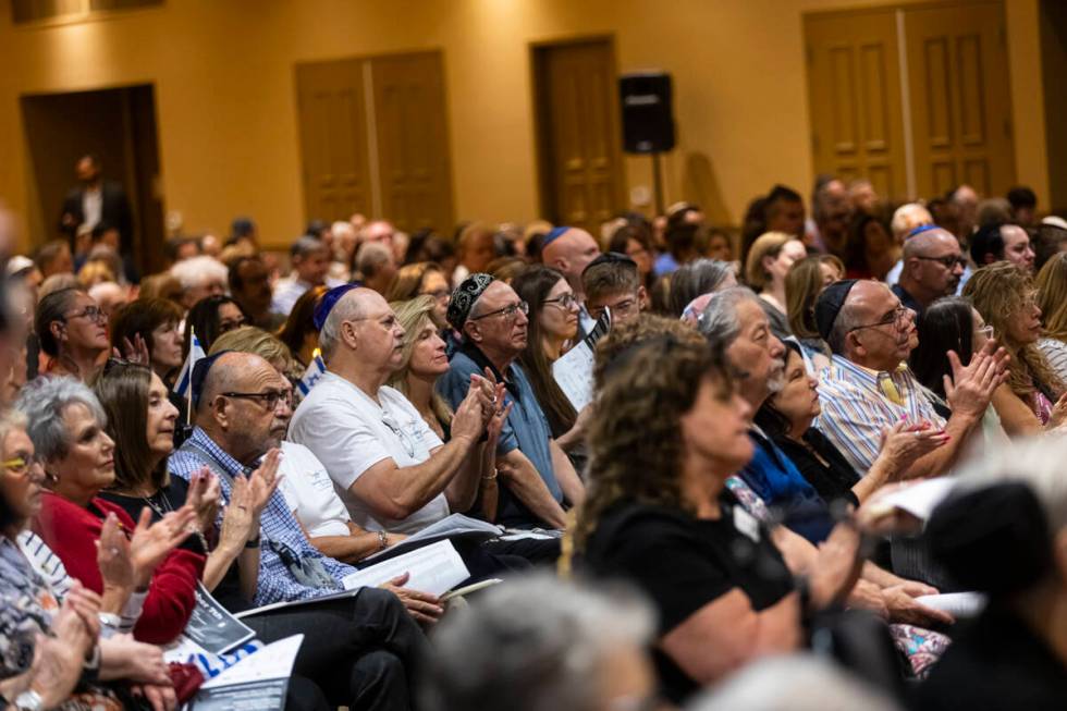 People clap during a ceremony at Midbar Kodesh Temple marking one year since the Oct. 7 terrori ...