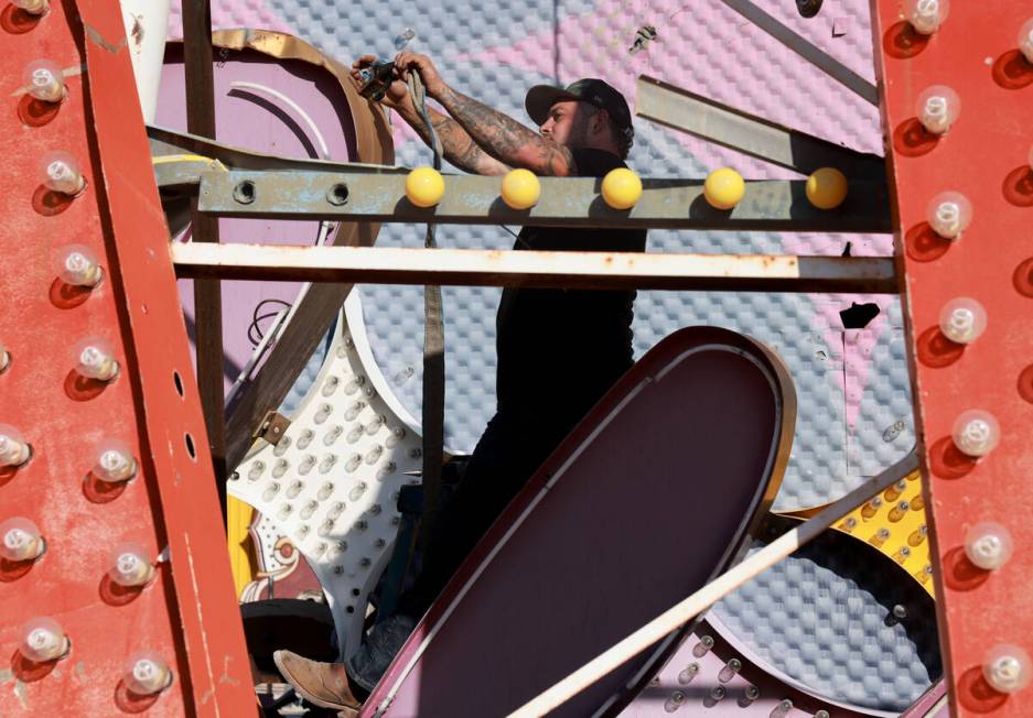 A YESCO sign company worker prepares to move the cursive sign from the Debbie Reynolds Hollywoo ...