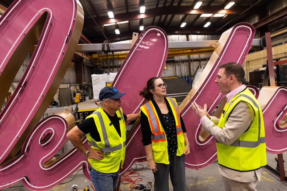 Todd Fisher, left, and YESCO sign designer Lisa Adams, an assistant original designer of the &# ...