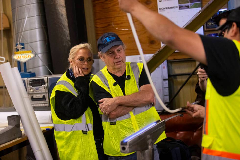 Todd Fisher, second from left, and wife Catherine Hickland get a demonstration from YESCO neon ...