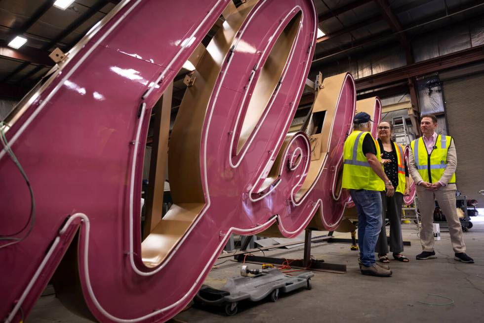 Todd Fisher, left, talks with YESCO sign designer Lisa Adams, an assistant original designer of ...