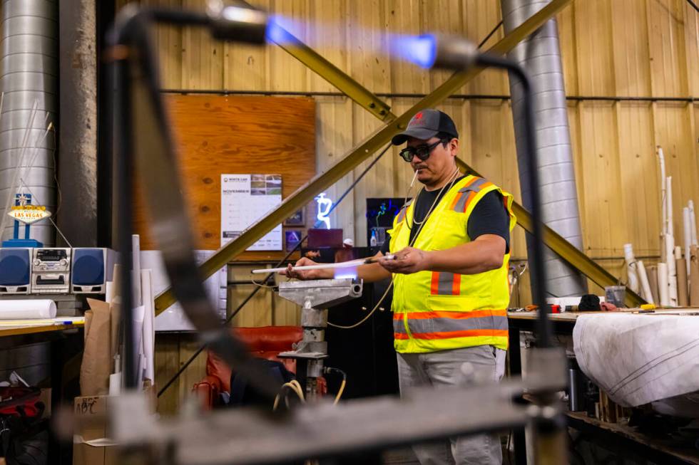 YESCO neon bender Oscar Gonzalez works on shaping a neon tube while working on the renovation o ...