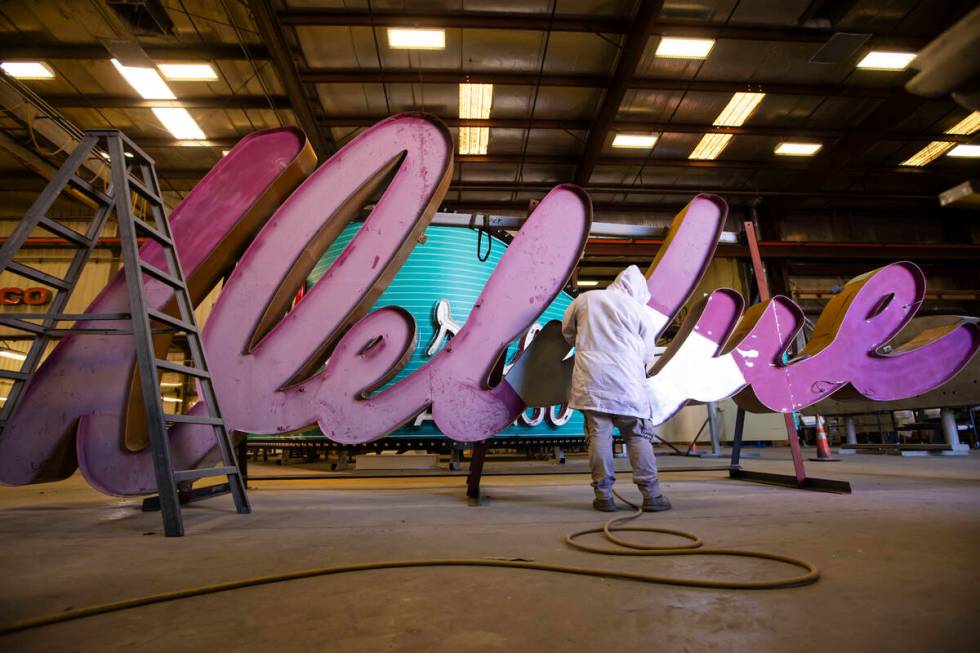 YESCO paint apprentice Cody Day sands down the “Debbie” sign from the former Debb ...