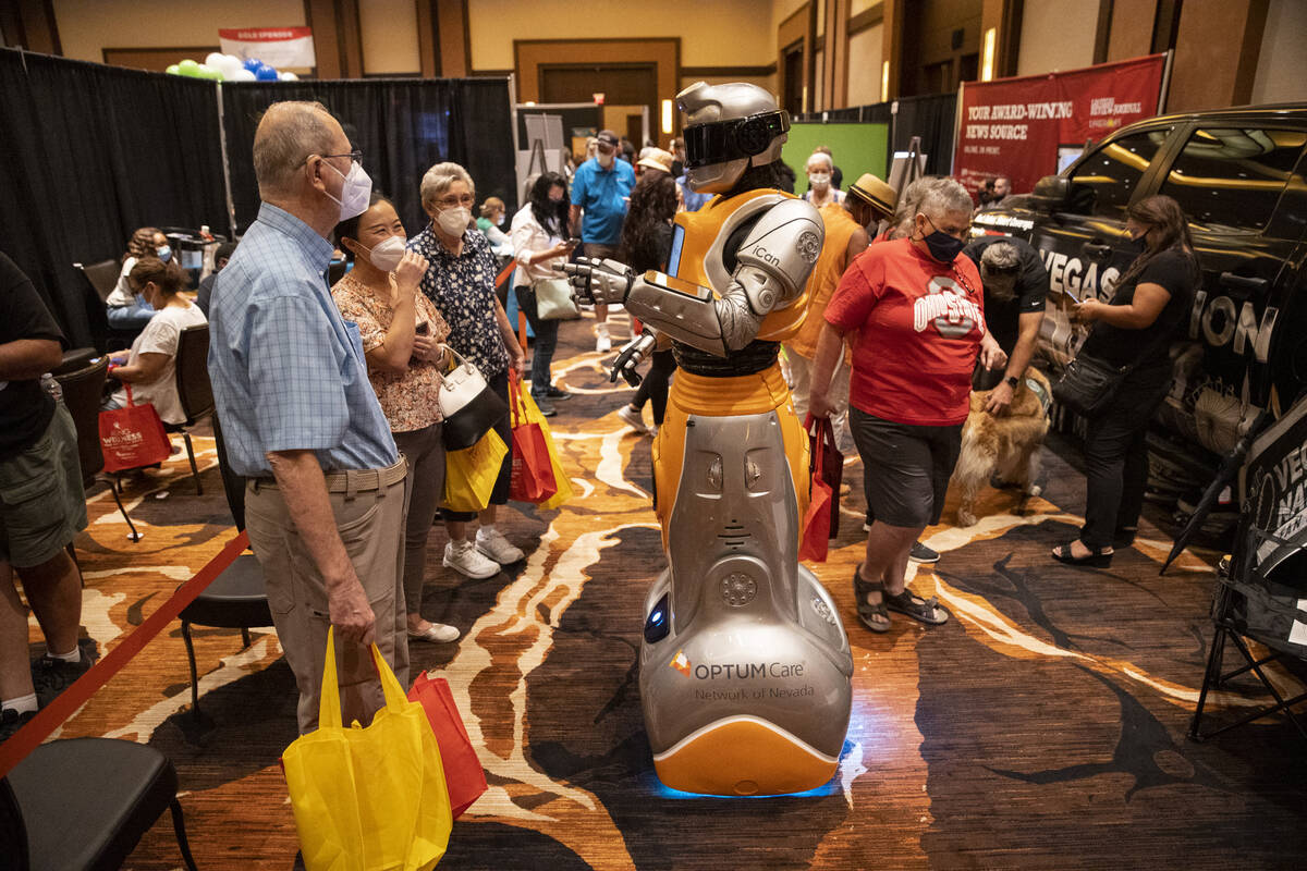 People attend the Aging Wellness Expo at the Red Rock hotel-casino in Las Vegas, Saturday, Aug. ...