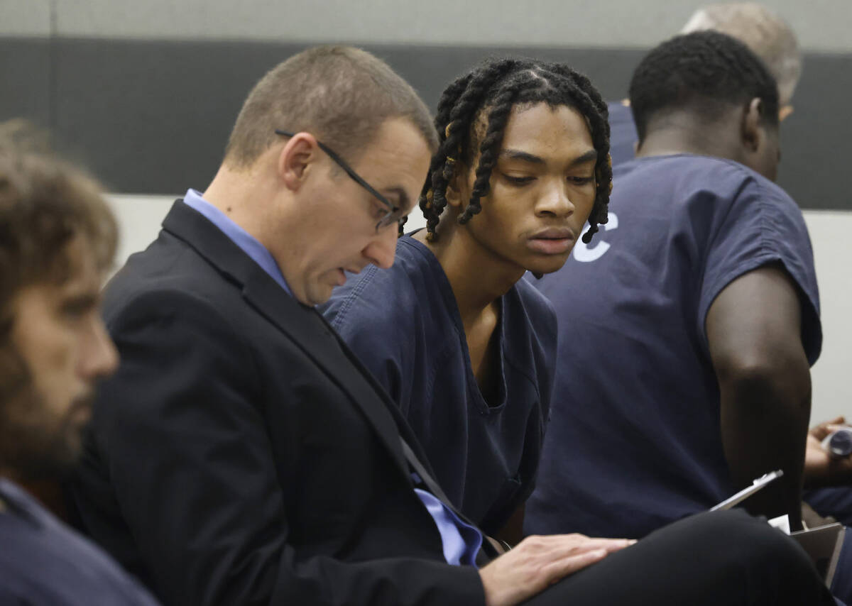 Serge Kamga, right, one of the two suspects arrested in connection with a fatal shooting that h ...