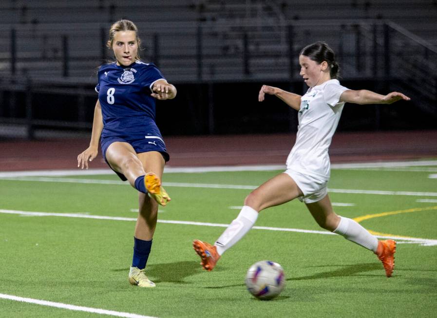 Centennial forward Claire Orme (8) kicks the ball away from Green Valley midfielder Melody McCo ...